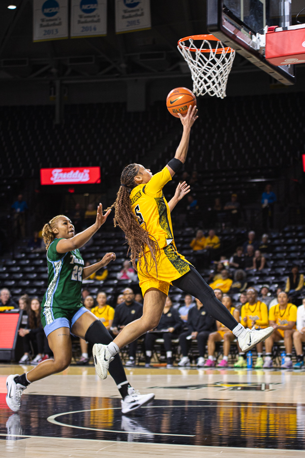Wichita State women's basketball graduate guard Diamond Richardson (5) goes up for a layup past a Tulane defender on Jan. 3. Richardson scored 15 points in the 70-60 loss.