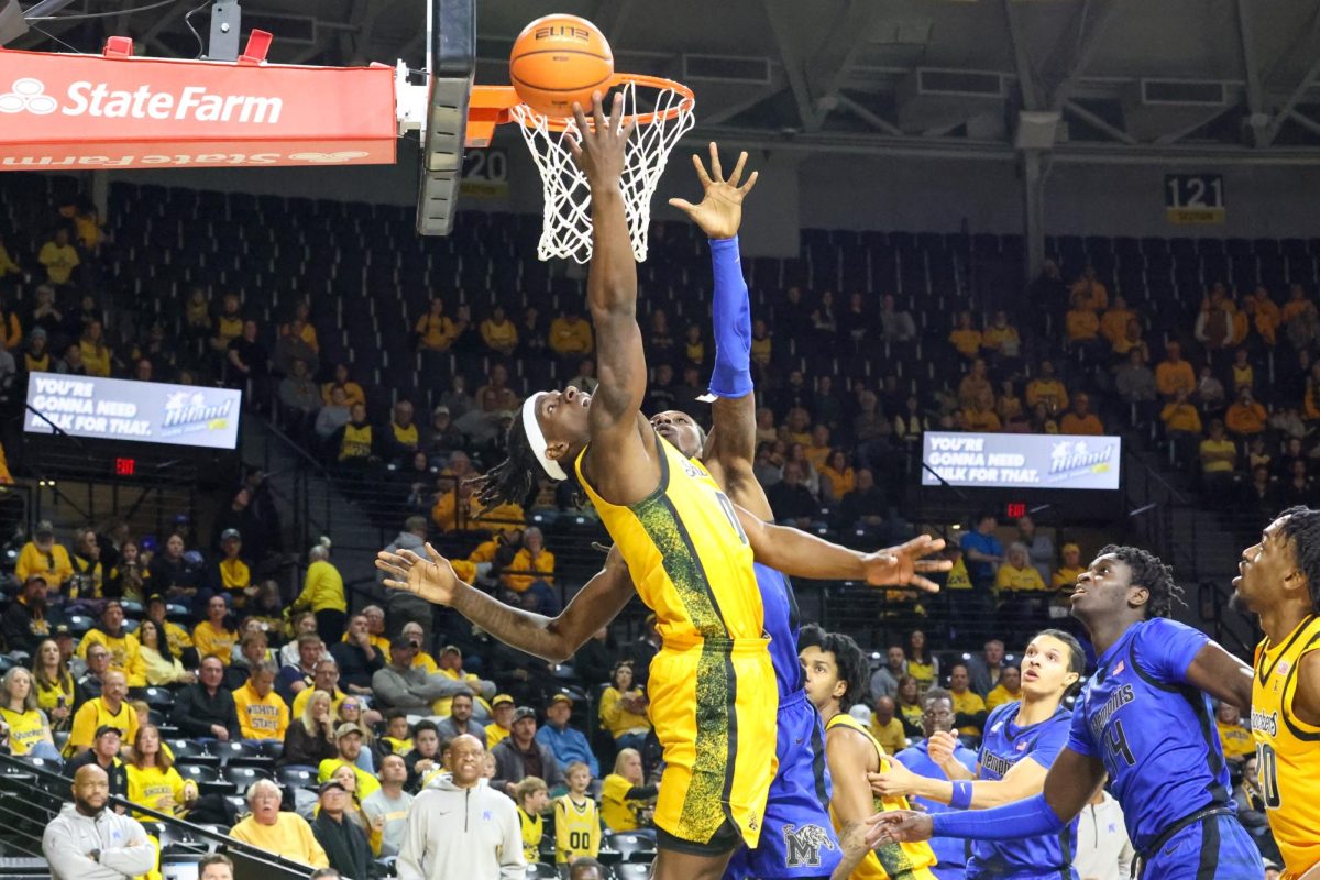 Wichita State men's basketball senior forward Karon Boyd (0) shoots a contested layup around Memphis' defense on Jan. 24. Boyd's 14 points were a part of a balanced attack that saw four Shockers reach double digits in their 74-59 win.