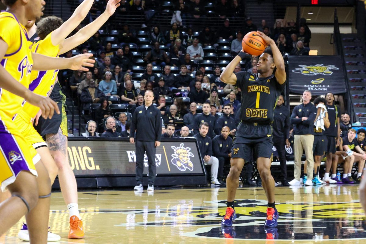 Wichita State men's basketball senior guard Kenyon Giles (1) shoots a 3-pointer from the logo against East Carolina on Jan. 21. Giles made five shots from deep in the win.