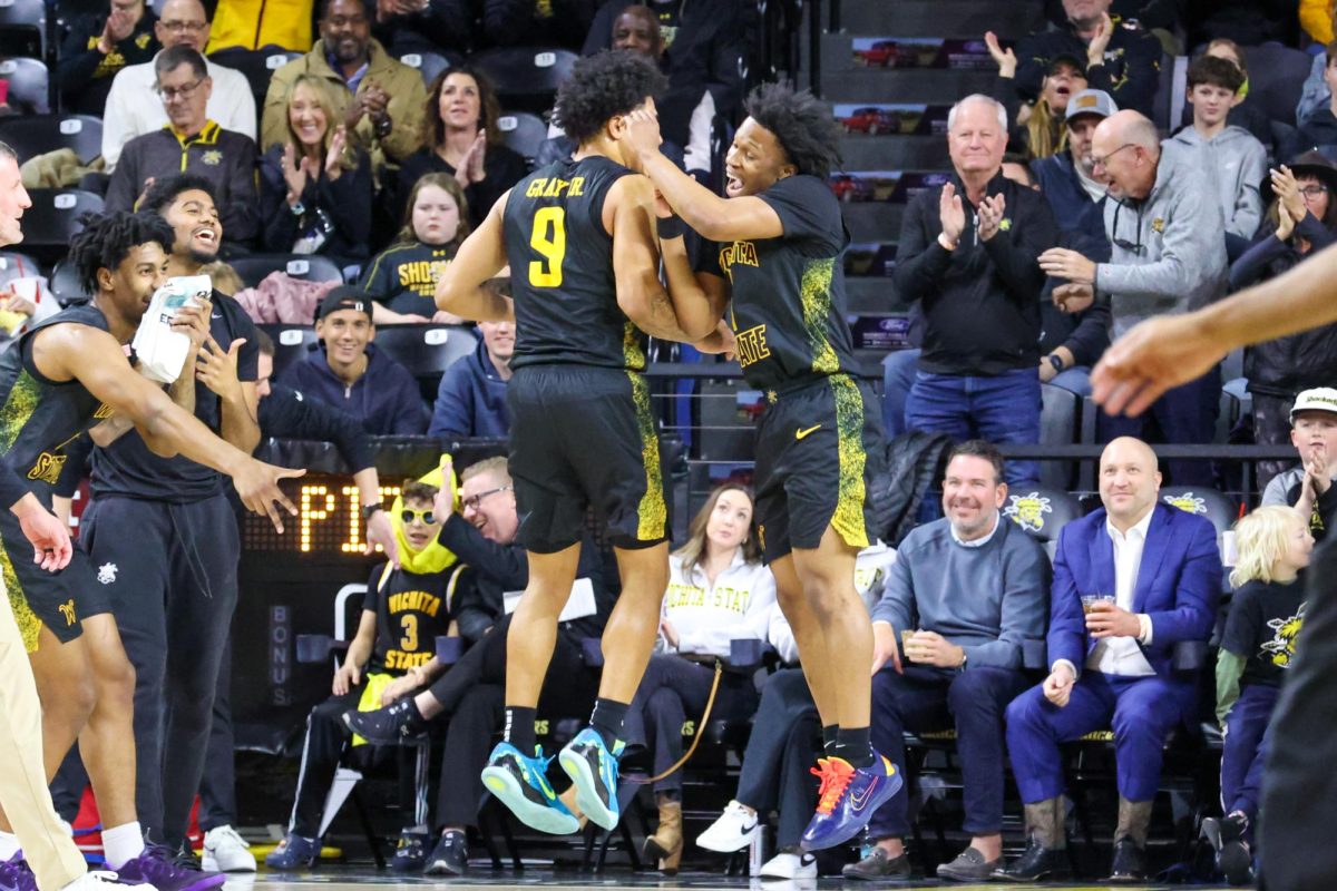 Wichita State men's basketball seniors Kenyon Giles (1) and Mike Gray Jr. (9) celebrate with each other during a game against East Carolina on Jan. 21. The Shockers won, 77-60.