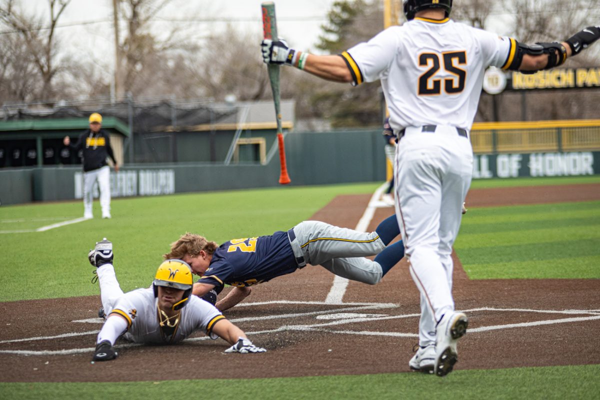 Wichita State baseball senior infielder Jayson Jones (23) slides headfirst into home against Northern Colorado on Feb. 13. The Shockers scored 11 runs in the win.