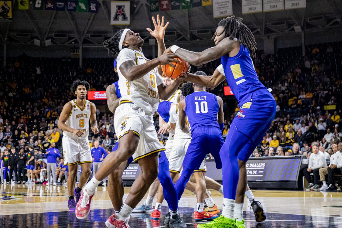 Wichita State men's basketball senior forward Karon Boyd (0) and Tulsa guard Ade Popoola (0) fight for the ball on Feb. 14. Boyd scored the last five points for the Shockers in their 81-77 win.