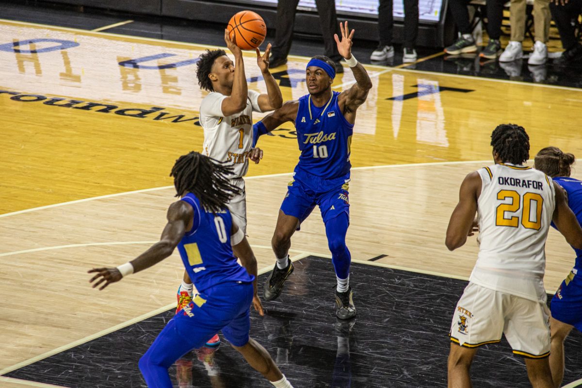 Wichita State men's basketball senior guard Kenyon Giles (1) puts up a floater past Tulsa guard Tylen Riley (10) on Feb. 14. The Shockers scored 52 points in the paint.