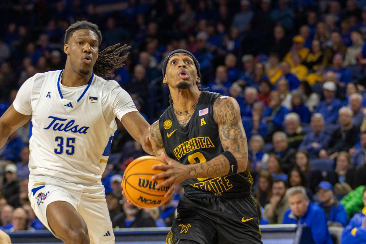 Wichita State men's basketball junior guard Dre Kindell (3) gathers to leap toward the hoop as a Tulsa player reaches out from behind him Feb. 1 at the Reynolds Center. Kindell scored 11 points in the second half against the Golden Hurricane.