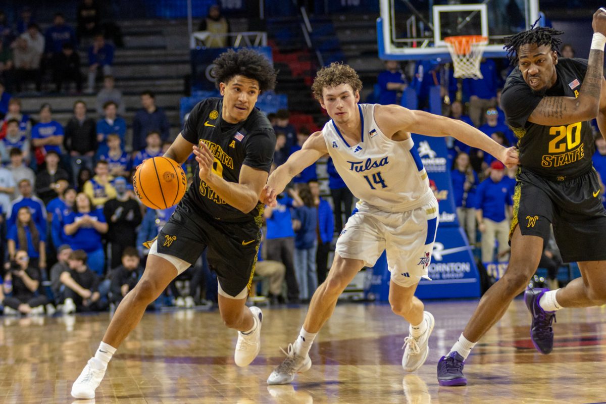Wichita State men's basketball senior guard Mike Gray Jr. (9) drives past Tulsa's Miles Barnstable (14) on Feb. 1 at the Reynolds Center. (File photo)