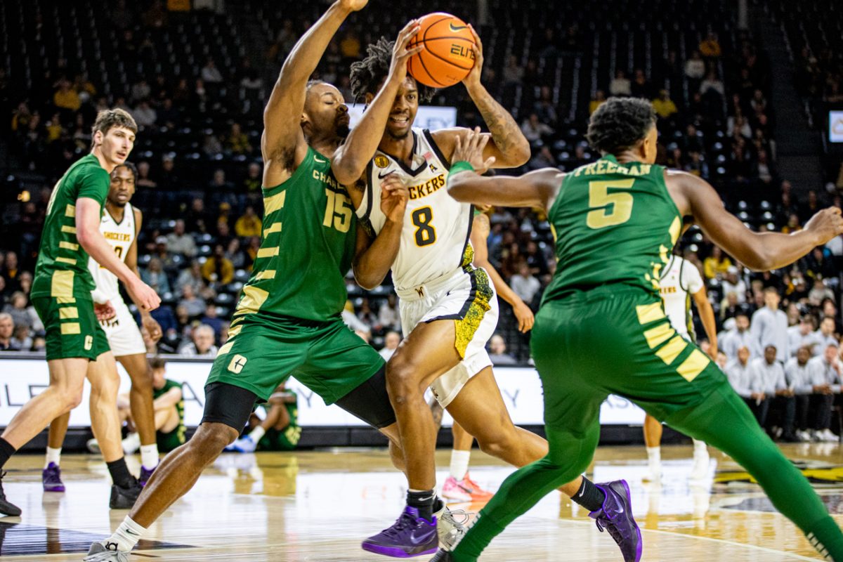 Wichita State men's basketball sophomore forward Dillon Battie (8) forces his way through two Charlotte defenders on Feb. 4 at Koch Arena. (File photo)