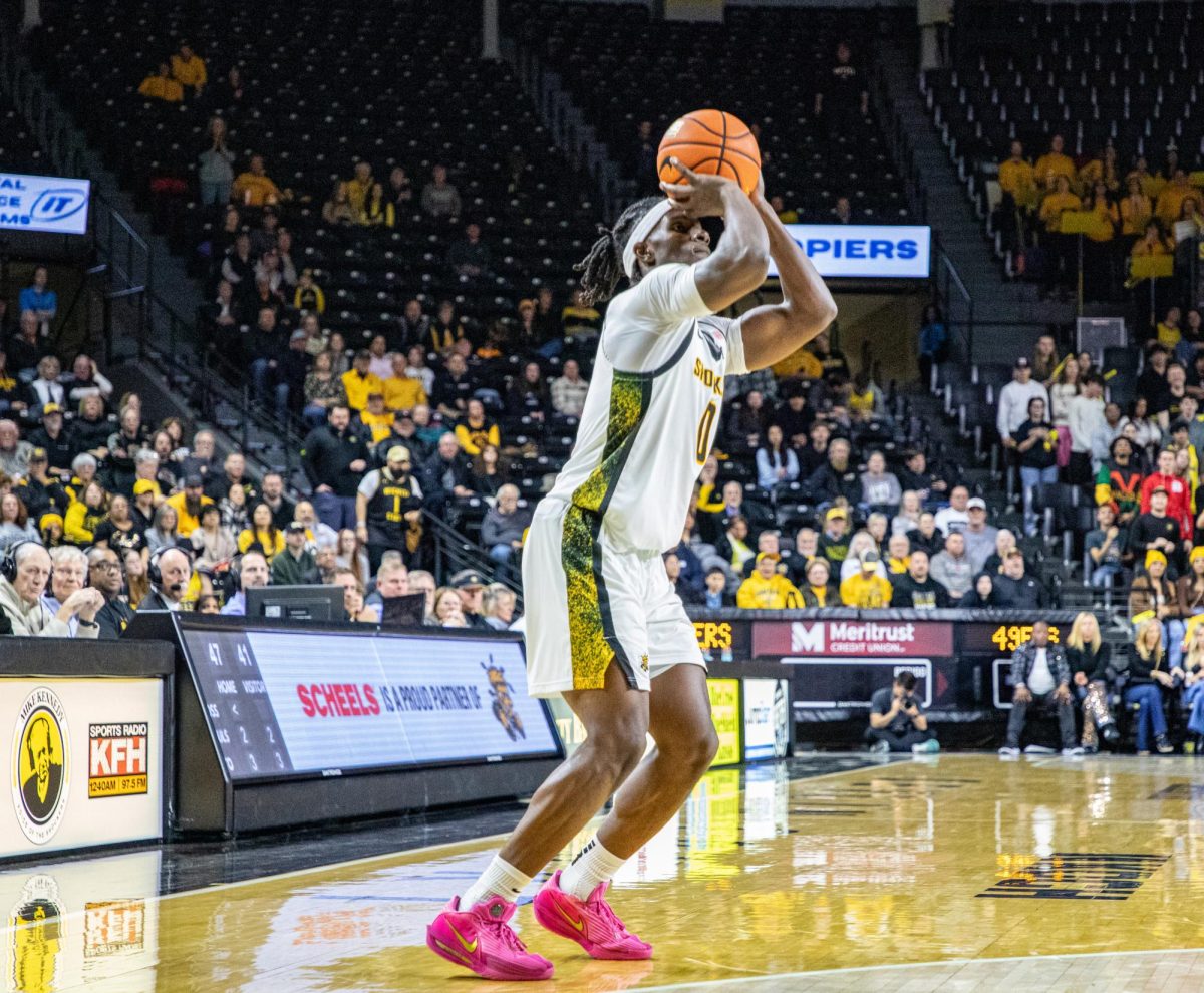 Wichita State men's basketball senior forward Karon Boyd (0) pulls up for three against Charlotte on Feb. 4. Boyd's 14 first-half points helped the Shockers maintain a 35-34 lead at the break.