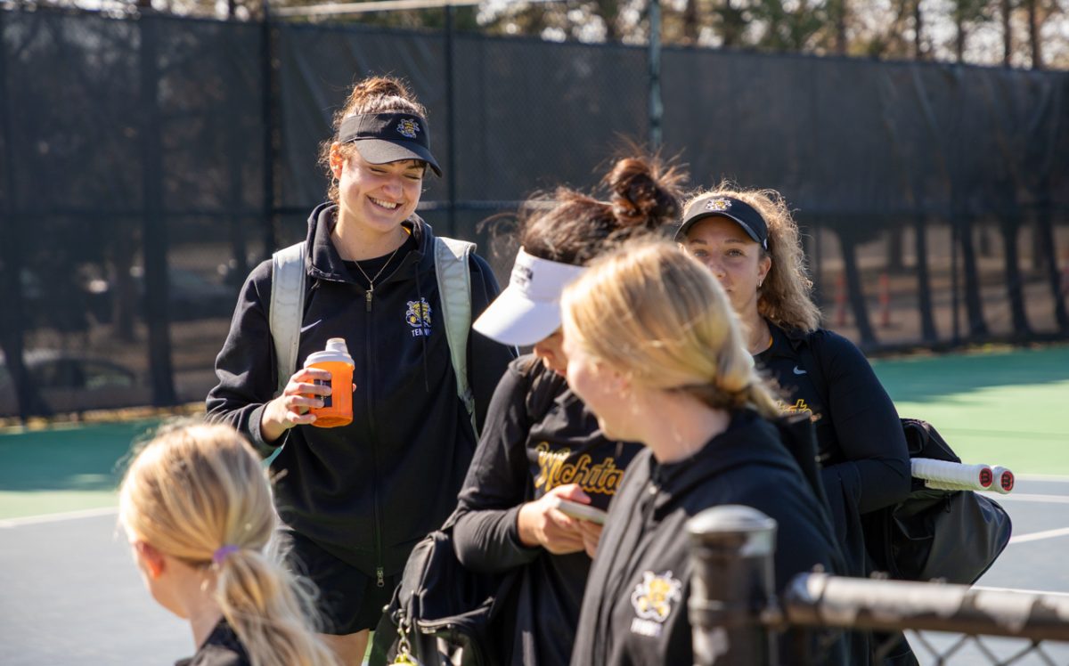 Wichita State women's tennis senior Theodora Chantava, left, grins after a win against Tulane on Feb. 21. Chantava won her doubles match but left her singles court unfinished as the Shockers swept Tulane.