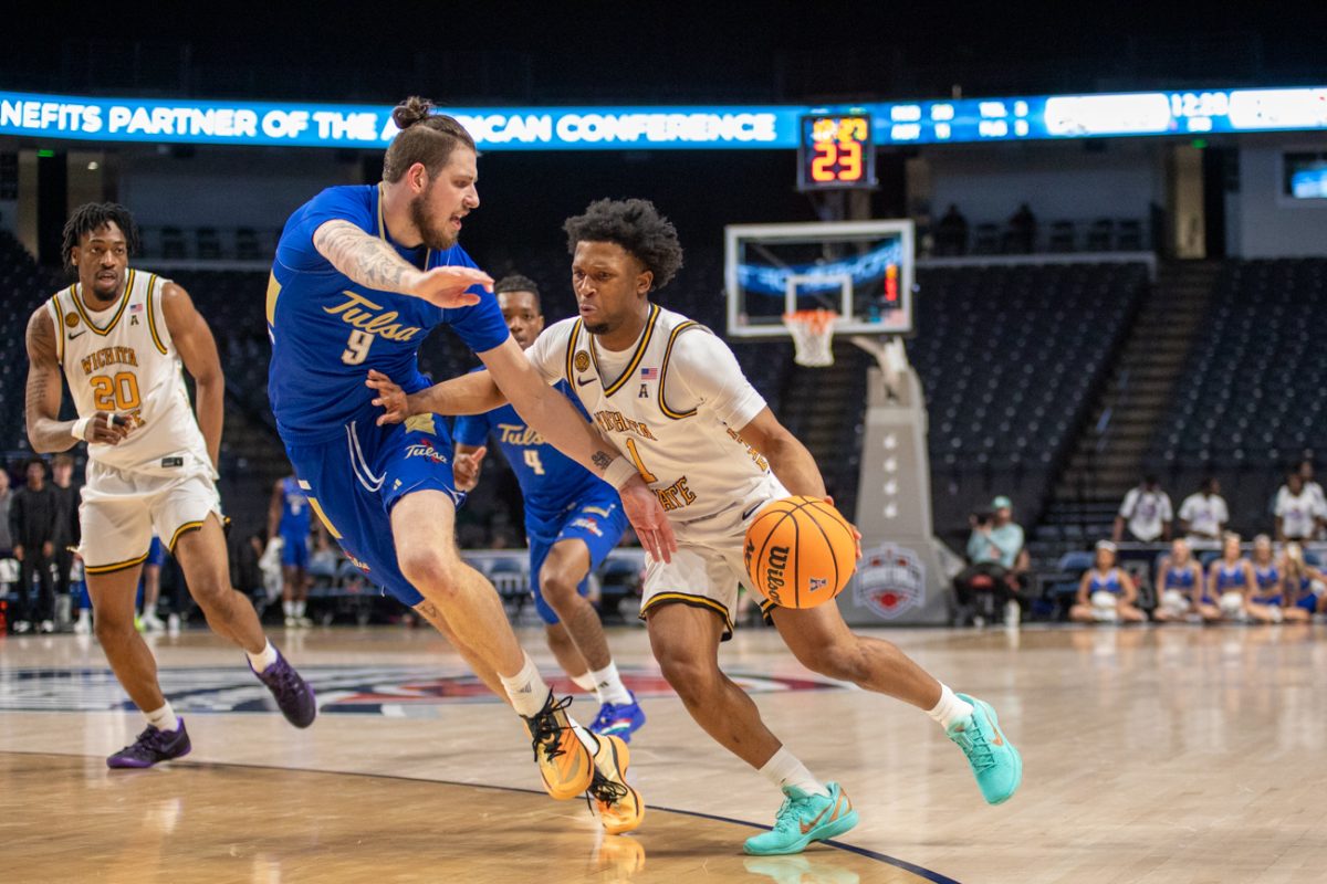 Wichita State men's basketball senior guard Kenyon Giles (1) pushes past Tulsa defender Tyler Behrend (9) on March 14 at Legacy Arena in Birmingham, Ala. (File photo)