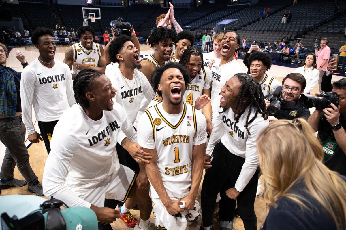 Wichita State men's basketball senior guard Kenyon Giles (1) celebrates with his teammates after winning the American Conference semifinal game against Tulsa on March 14 at Legacy Arena in Birmingham, Ala. The win moved the Shockers to the championship game against South Florida.