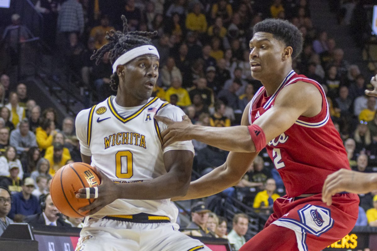 Wichita State men's basketball senior forward Karon Boyd (0) protects the ball against a Florida Atlantic Owl on March 7 at Koch Arena. The Shockers won their senior day game, 88-70.