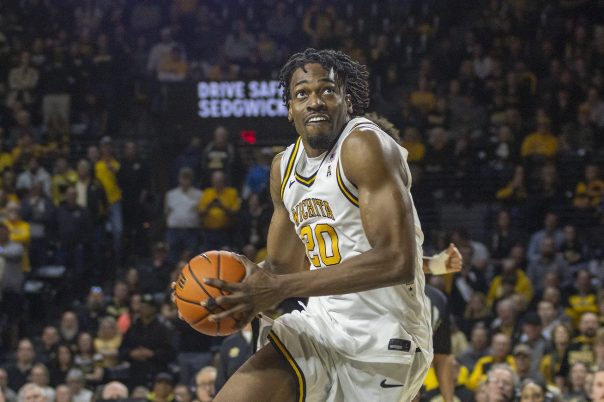 Wichita State men's basketball senior center Emmanuel Okorafor (20) gathers to dunk the ball against Florida Atlantic on March 7 at Koch Arena. Okorafor finished the game with 16 points and six rebounds.