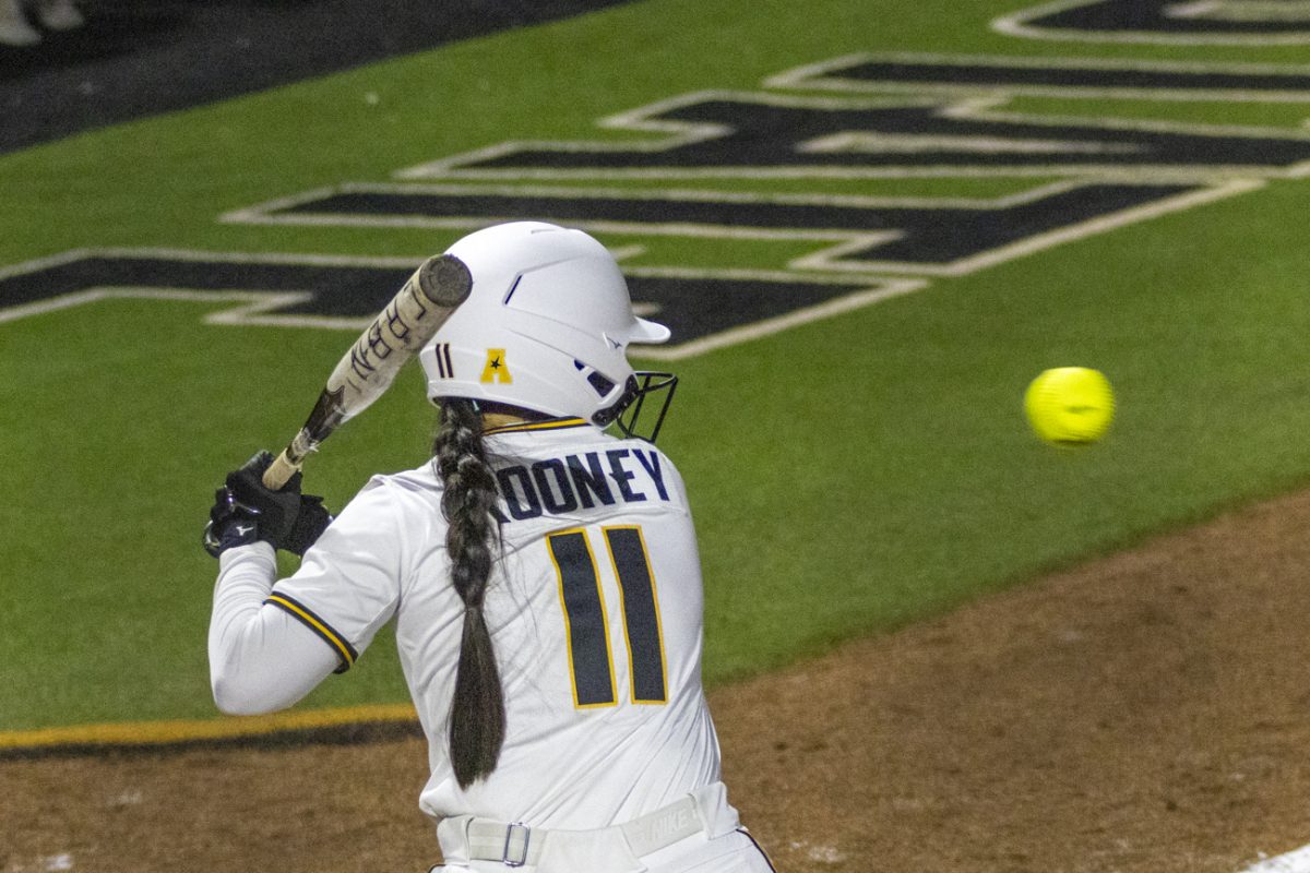 Wichita State softball freshman outfielder Mackenzie Rooney (11) watches a pitch against Kansas on March 4 at Wilkins Stadium.