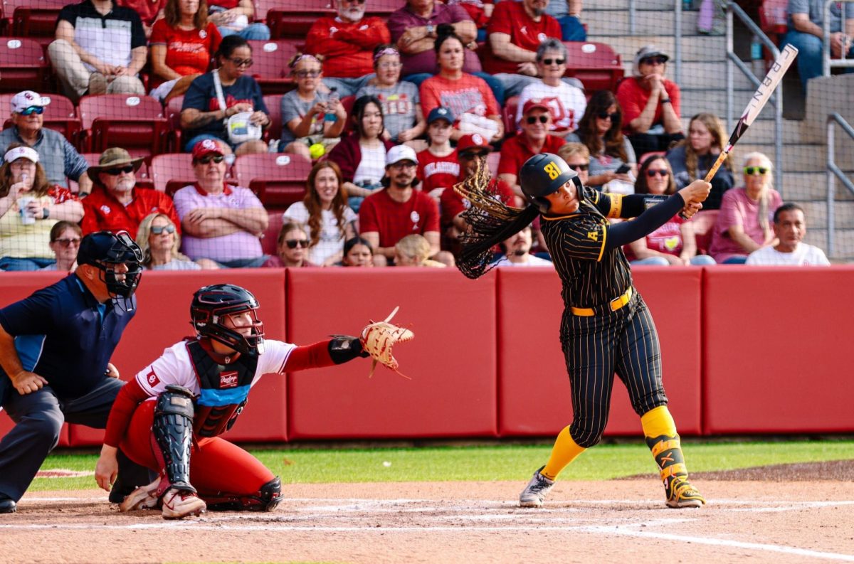 Wichita State softball sophomore Ausha Moore (81) follows through after making contact on her 11th home run this season against Oklahoma March 31 at Love's Field in Norman, Okla. (Photo courtesy of Wichita State Athletics)