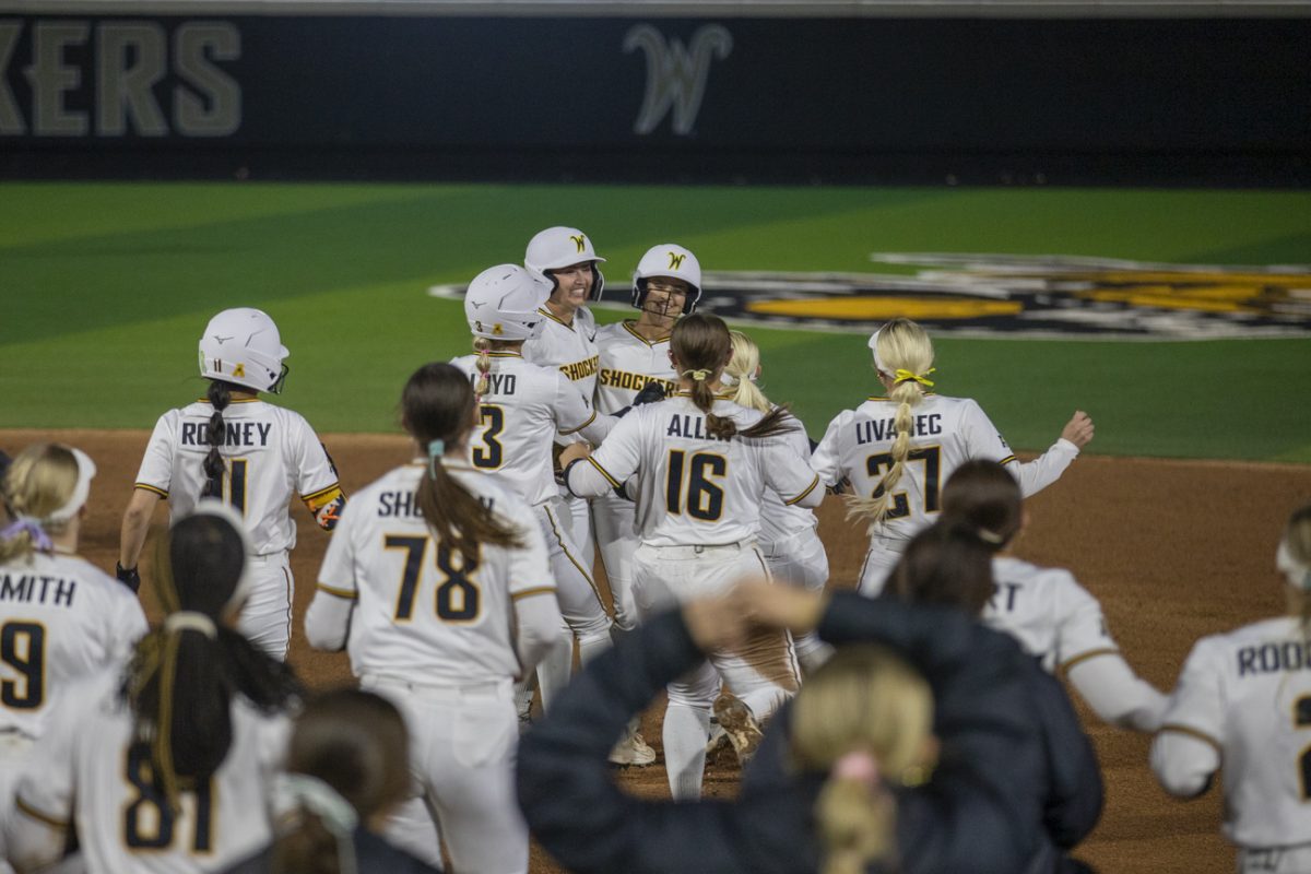 Wichita State's softball team celebrates with senior Jodie Epperson (22) after she hit a walk-off single against UAB on March 13 at Wilkins Stadium. The Shockers won 6-5.