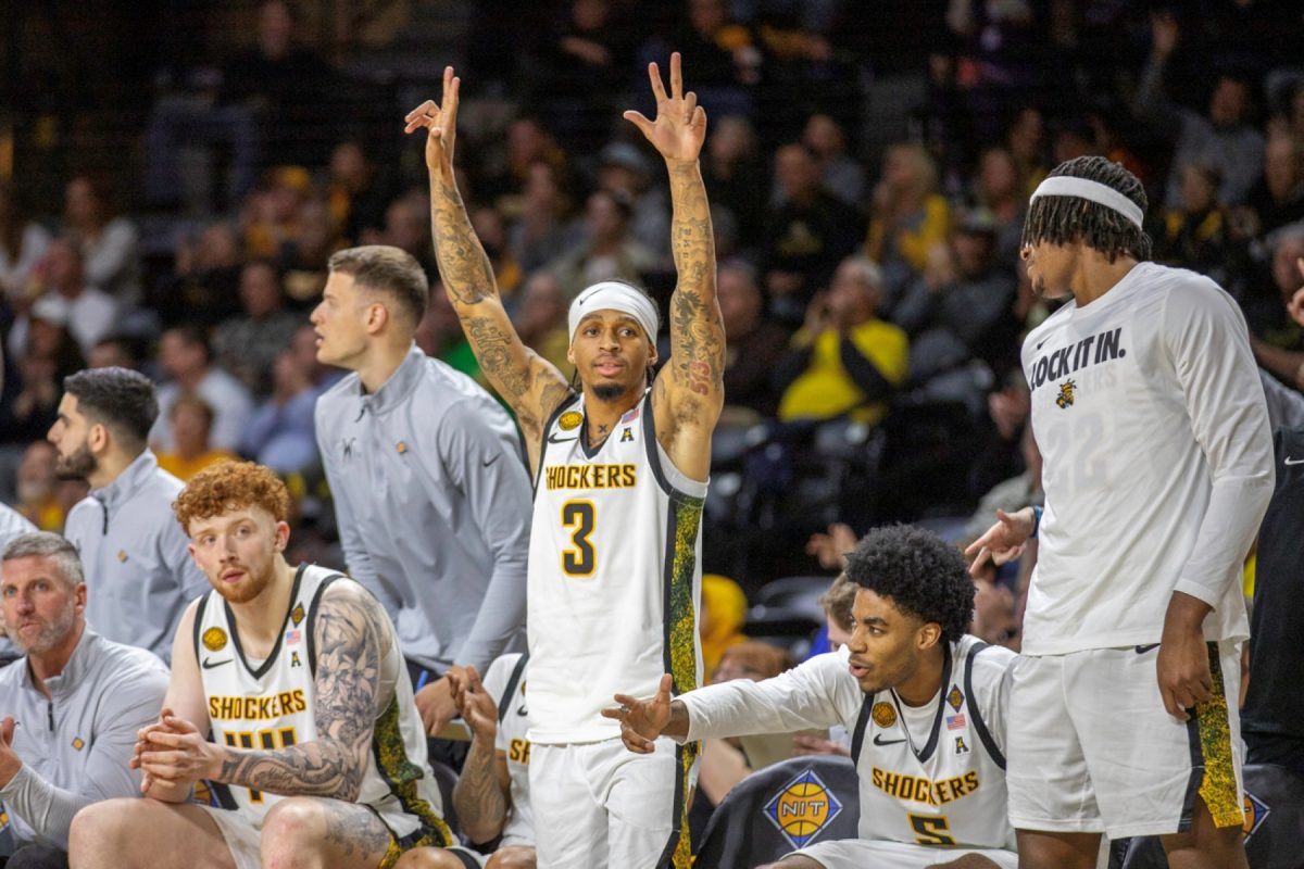 The Wichita State men's basketball team celebrates a 3-pointer against Wyoming in the first round of the NIT on March 17 at Koch Arena. The Shockers won, 74-70, to advance to the second round.