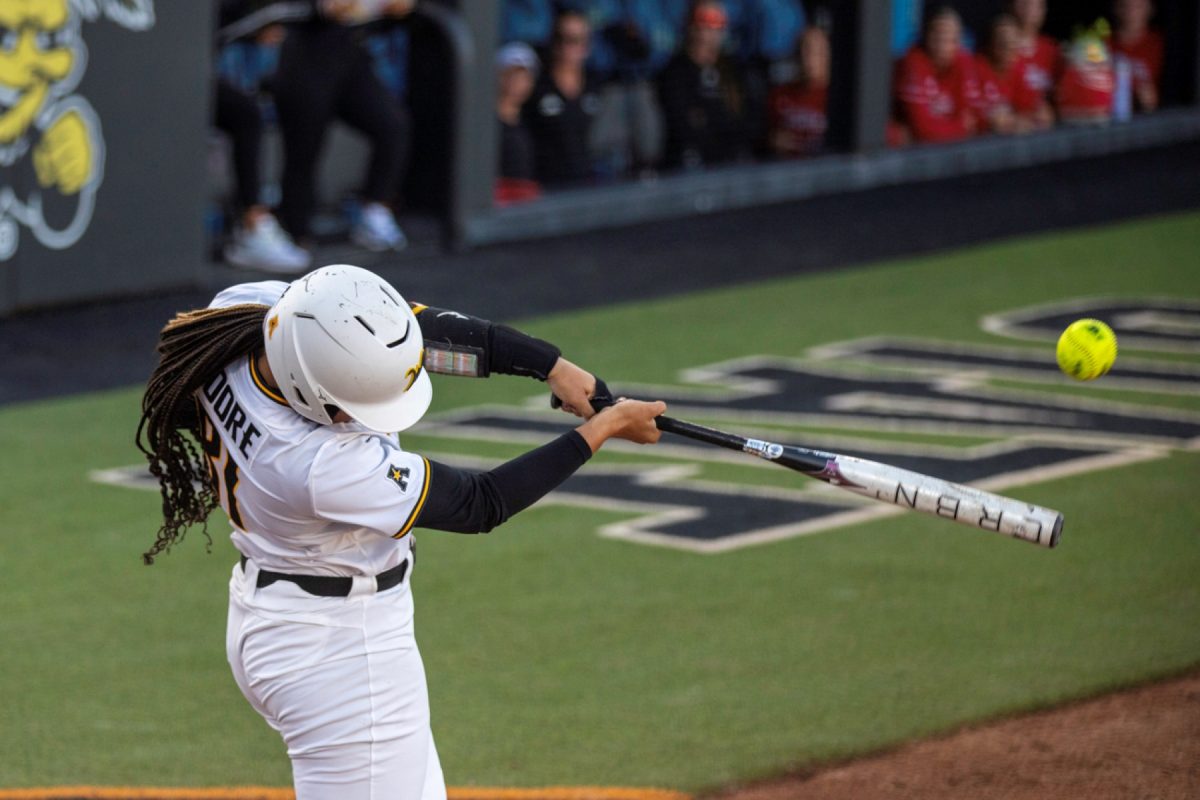 Wichita State softball sophomore infielder Ausha Moore (81) makes contact against Florida Atlantic on March 20 at Wilkins Stadium. Moore hit 1-3 in the win against the Owls.