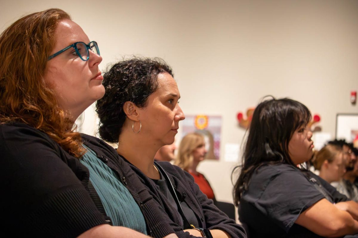 Audience members listen as various faculty artists give brief introductions to their fields of focus and their methodology. This artist talk is part one of two.