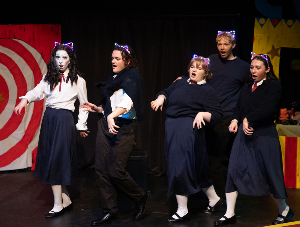 Student performers dance in "Space Age Bachelor Man" with glowing cat ear headbands. "Ride the Cyclone" was performed at Welsbacher theater.