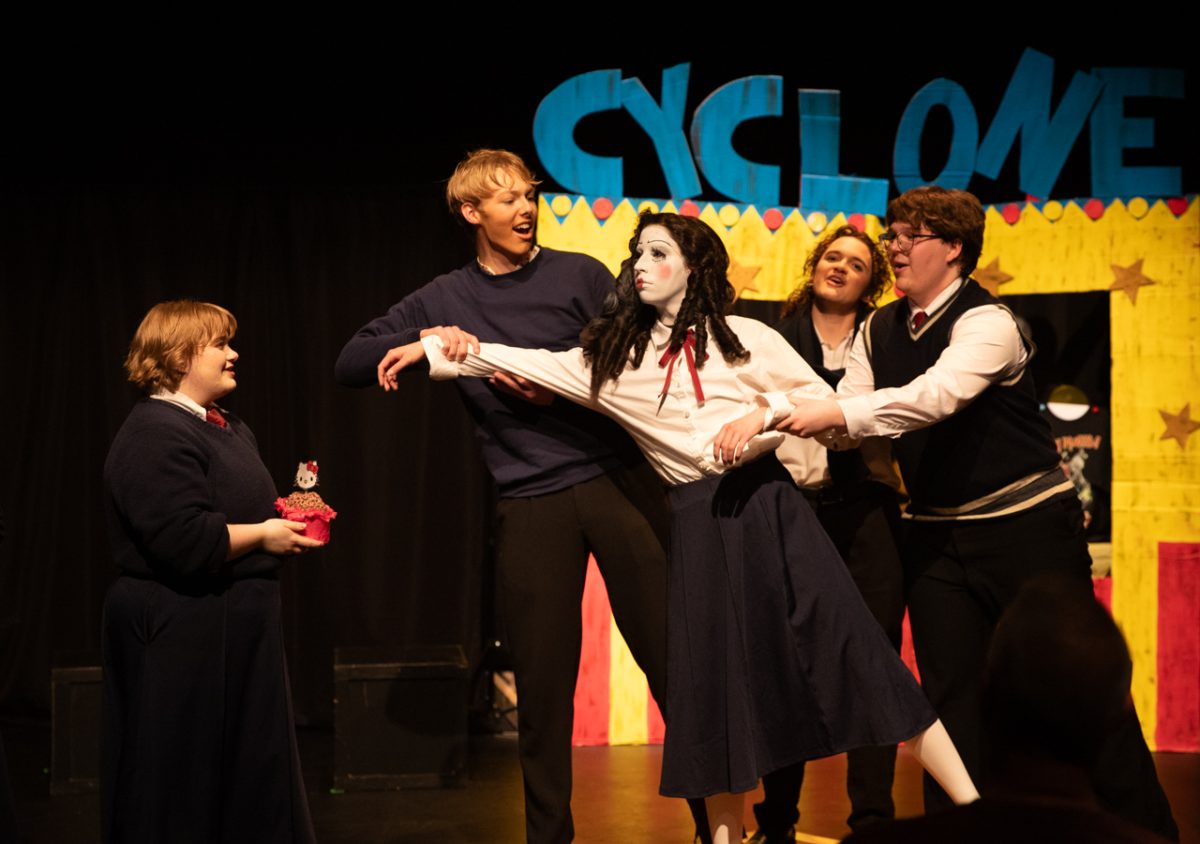Actors Sebastian McGinity-Kinderknecht, Leo Porcaro and Connor Harris dance with Aubrey Johnson as Alyssa Watson hands her a deep-fried "Hello Kitty" cupcake. The characters were celebrating her birthday after her song, "The Ballad of Jane Doe."
