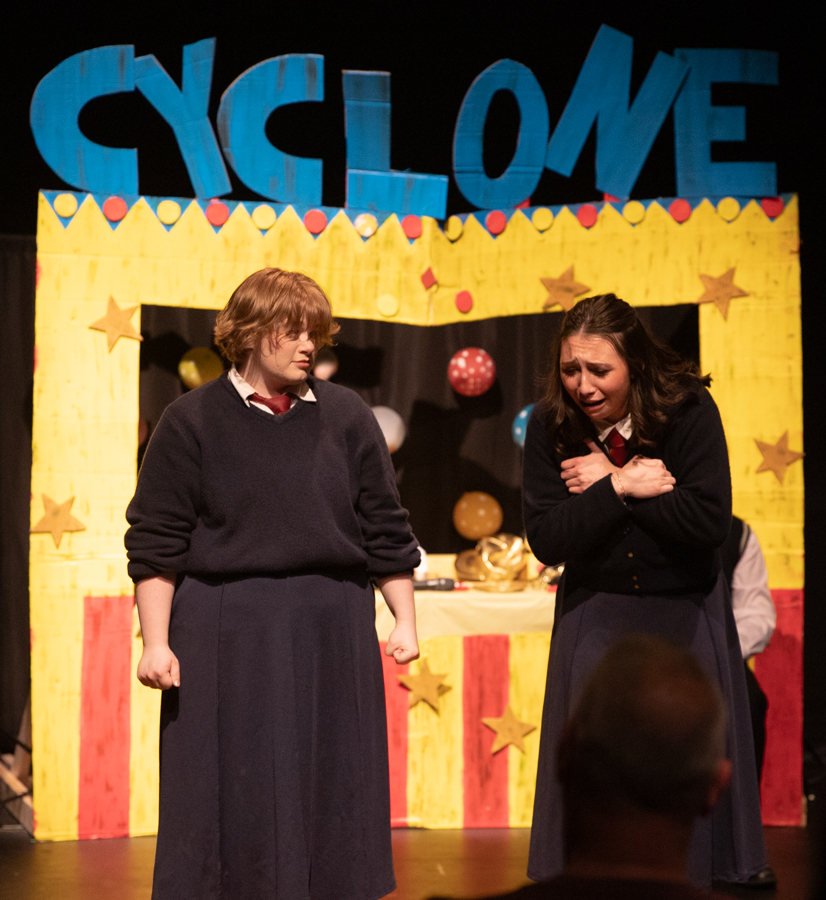 Sophia Fruits holds her chest after Alyssa Watson's character punched her. Watson is the president of the Wichtia State Musical Theatre Company.