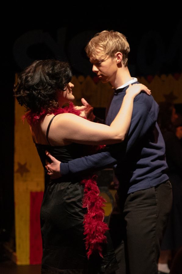 Leo Porcaro dances with Sebastian McGinity-Kinderknecht in character. Porcaro was singing his solo song, "Noel's Lament."