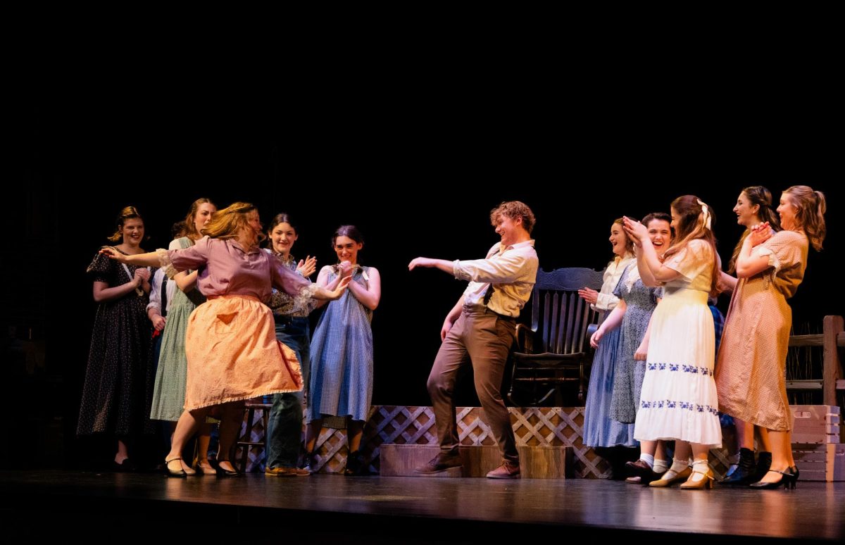 Mitchell Krueger as Top spins a member of the cast as others laugh and clap during Wichita State Opera Theatre’s production of The Tender Land at Miller Concert Hall on March 6, 2026.