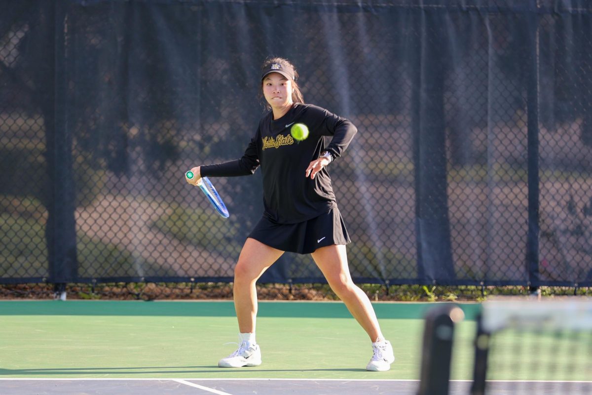 Wichita State women's tennis junior Xin Tong Wang bites her lip before a strike against South Florida March 27 at the Sheldon Coleman Tennis Complex. Wang won her singles match in straight sets 6-2, 6-2.