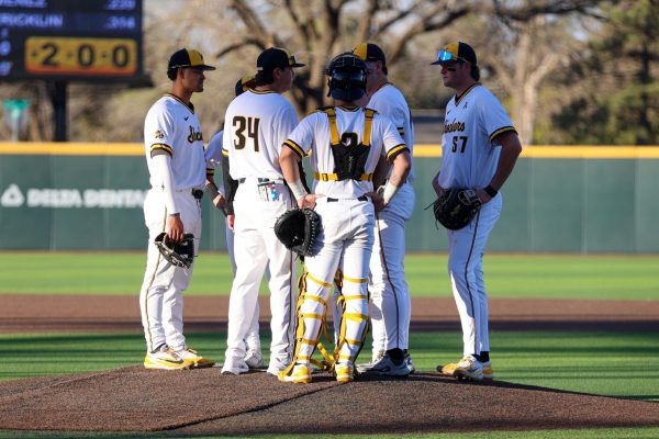 Wichita State baseball pitching coach Anthony Claggett (34) meets with the infield during a game against Charlotte on March 20 at Eck Stadium. The Shockers gave up just three runs to the 49ers. (File photo)