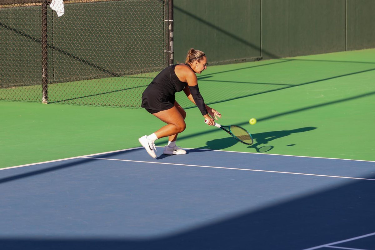 Wichita State women's tennis senior Kristina Kudryavtseva dips down to return the ball against South Florida March 27 at the Sheldon Coleman Tennis Complex. Krudryavtseva won her doubles match 6-4.