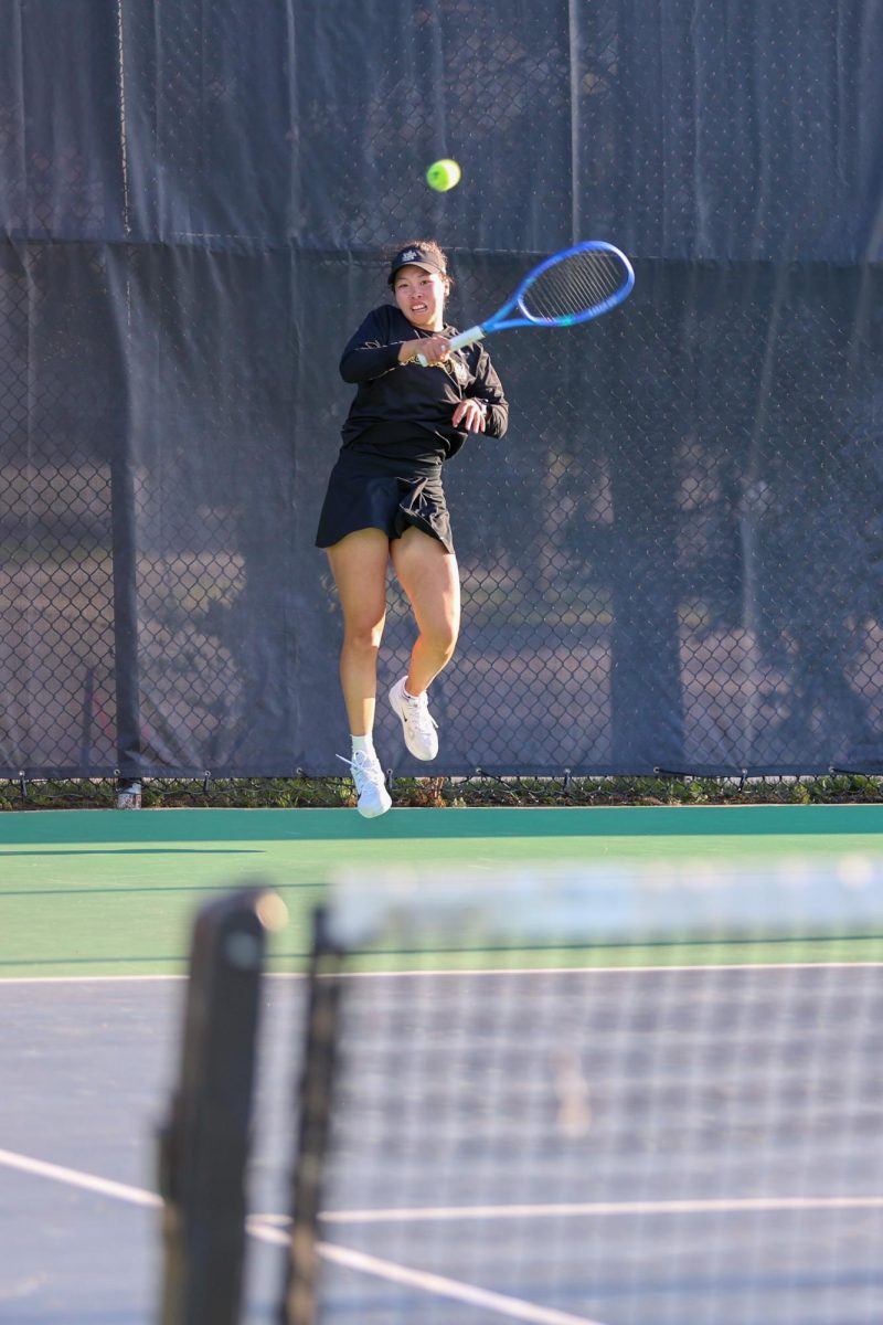 Wichita State women's tennis junior Xin Tong Wang jumps to return the ball against South Florida on March 27 at the Sheldon Coleman Tennis Complex. Wang played on singles court No. 1.