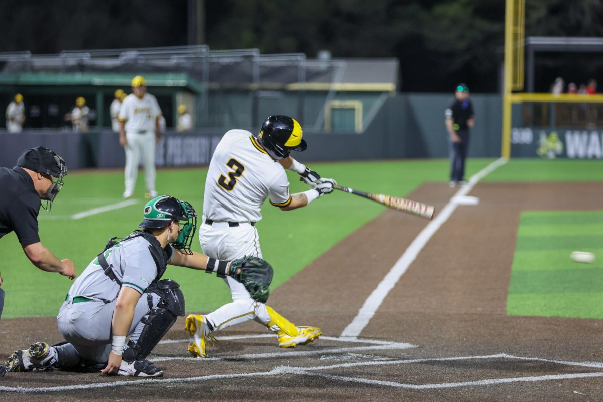 Wichita State baseball junior catcher Ethan Gonzalez (3) makes contact against Charlotte on March 20 at Eck Stadium. Gonzalez hit 1-3 at the plate.