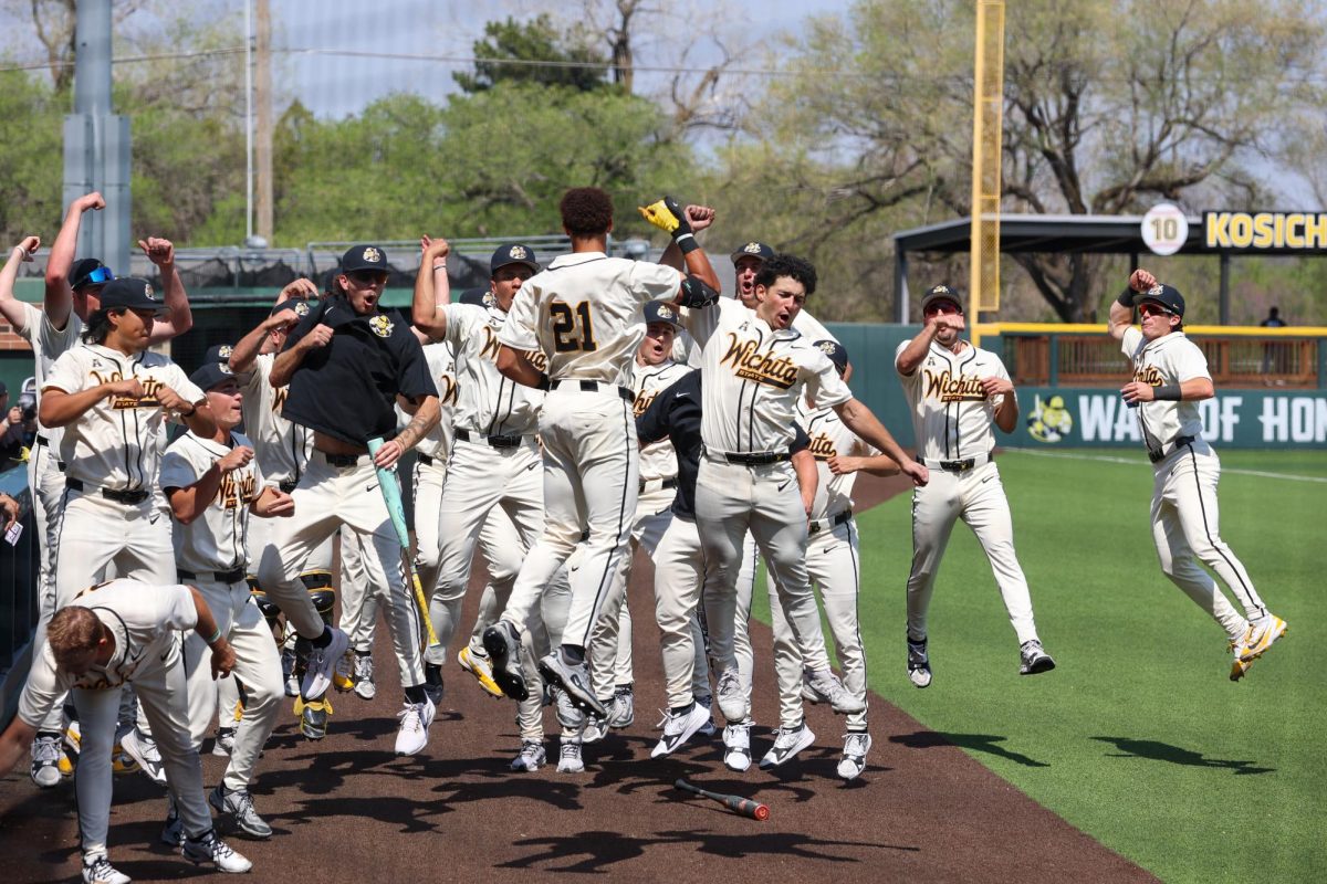 Wichita State baseball senior outfielder Jaden Gustafson (21) celebrates with his teammates after hitting a grand slam against Washburn March 31 at Eck Stadium. Gustafson's sixth home run this season helped lift the Shockers over the Ichabods.