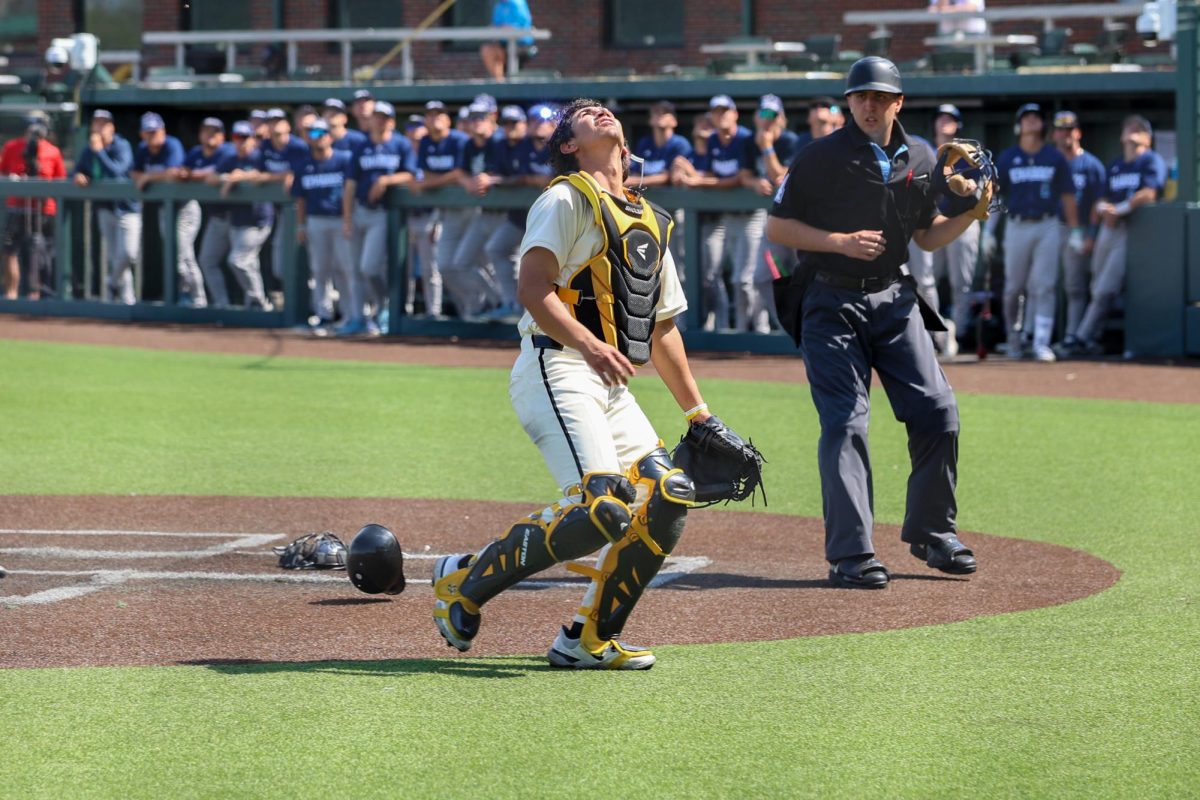 Wichita State baseball junior catcher Dominic Archila (36) looks toward the sky to track a pop up against Washburn March 31 at Eck Stadium. Archila started his first game of the season after redshirting at Texas Tech last season.