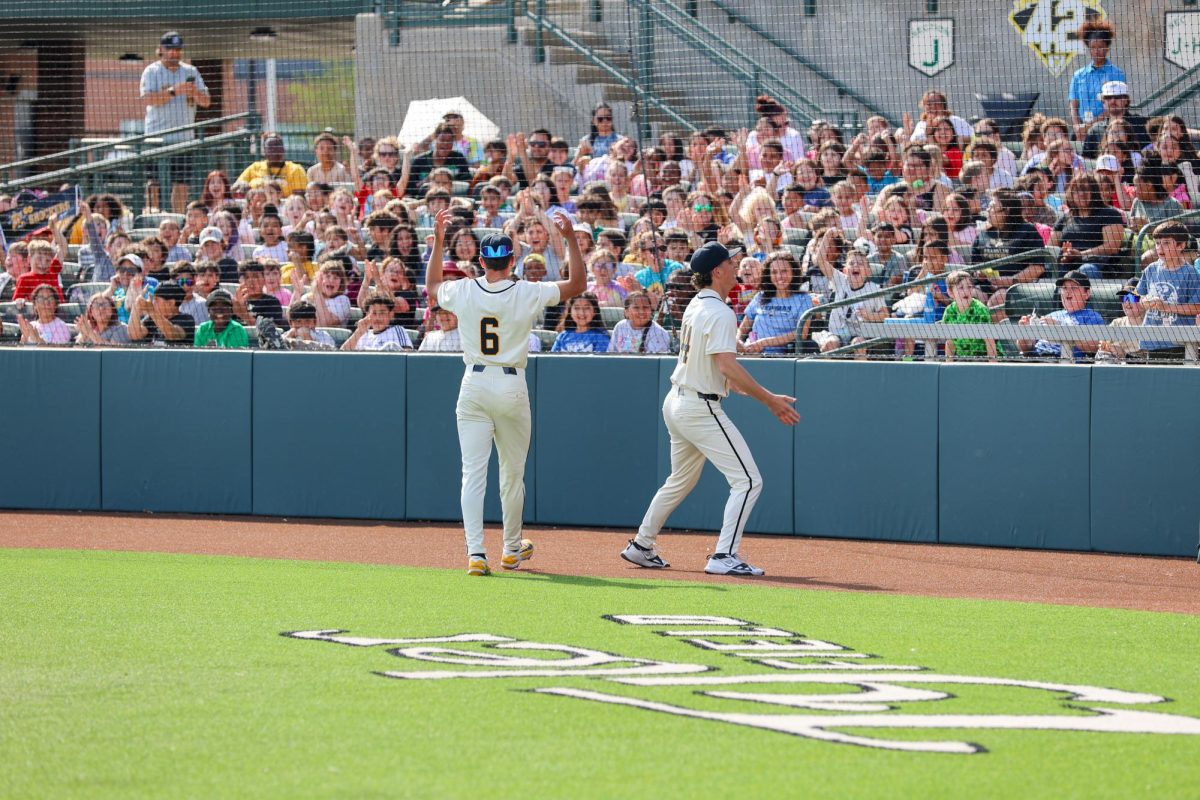 Wichita State baseball pitchers Ethan Rogers (6) and Brady Hamilton (44) hype the crowd of mostly Wichita-area students during the Kid's Day Game against Washburn March 31 at Eck Stadium. The attendance of students was around 2,000.