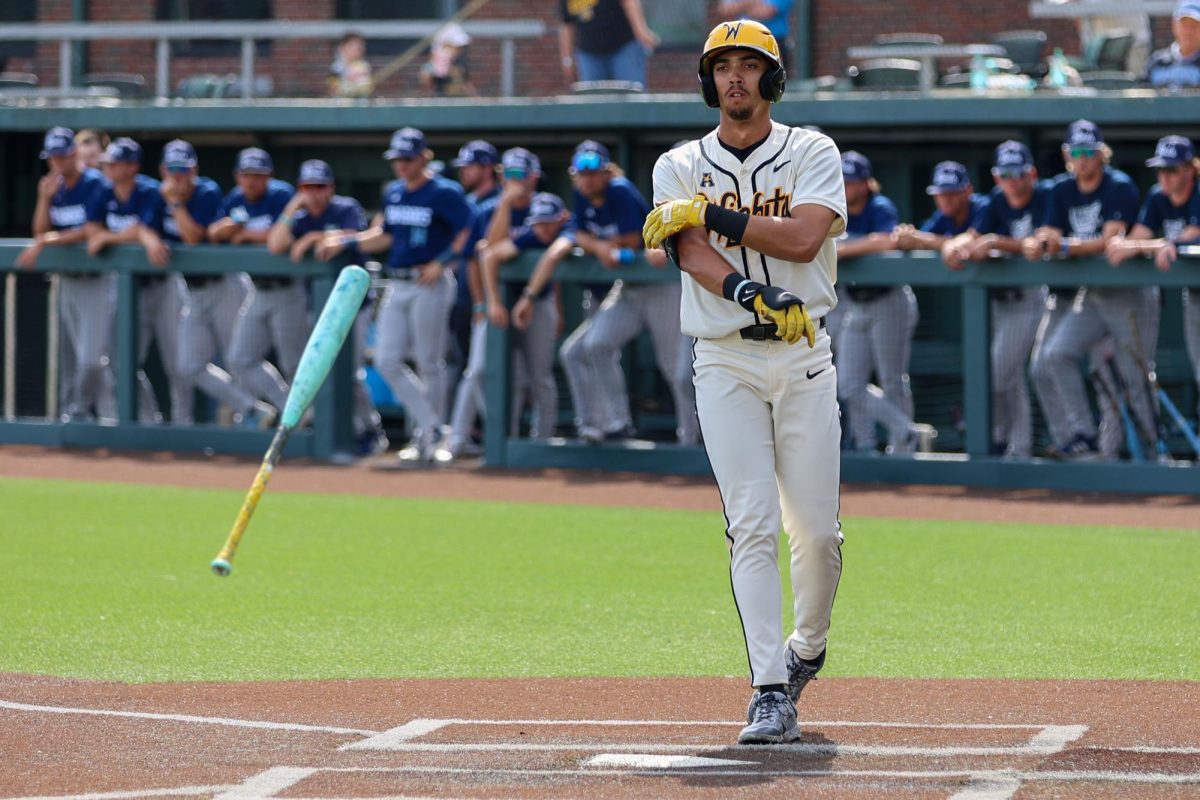 Wichita State baseball outfielder Jaden Gustafson (21) tosses his bat after coercing a walk against Washburn March 31 at Eck Stadium. Gustafson has been walked 21 times this season.