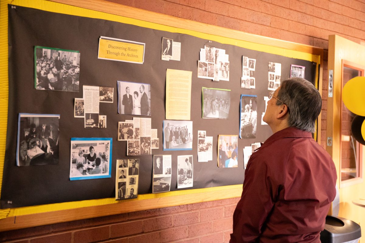 A WSU alum looks at archives during an open house for the College of Education. The open house was held in celebration of the college's centennial.