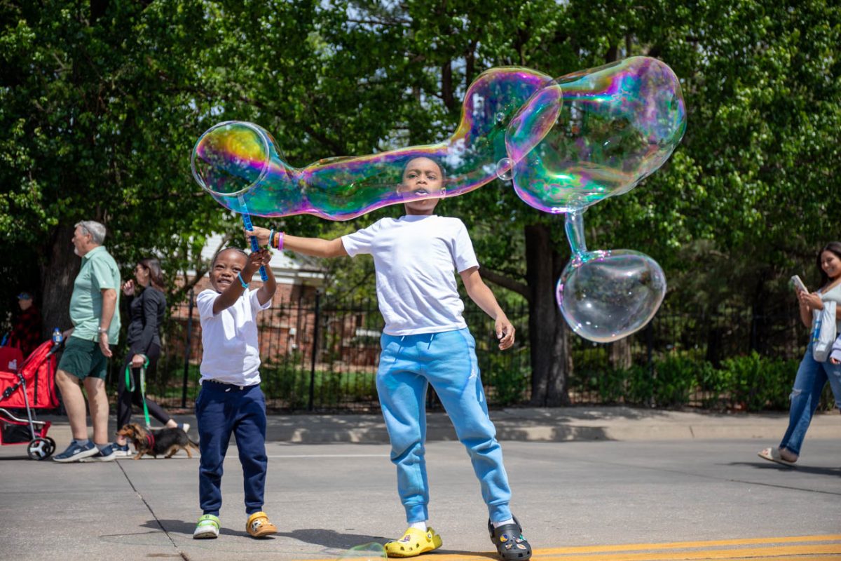 Two children blow bubbles at Open Streets ICT - WSU and Shocker Neighborhood on April 19. The event shut down 17th Street between Volustia and Oliver from noon to 4 p.m.