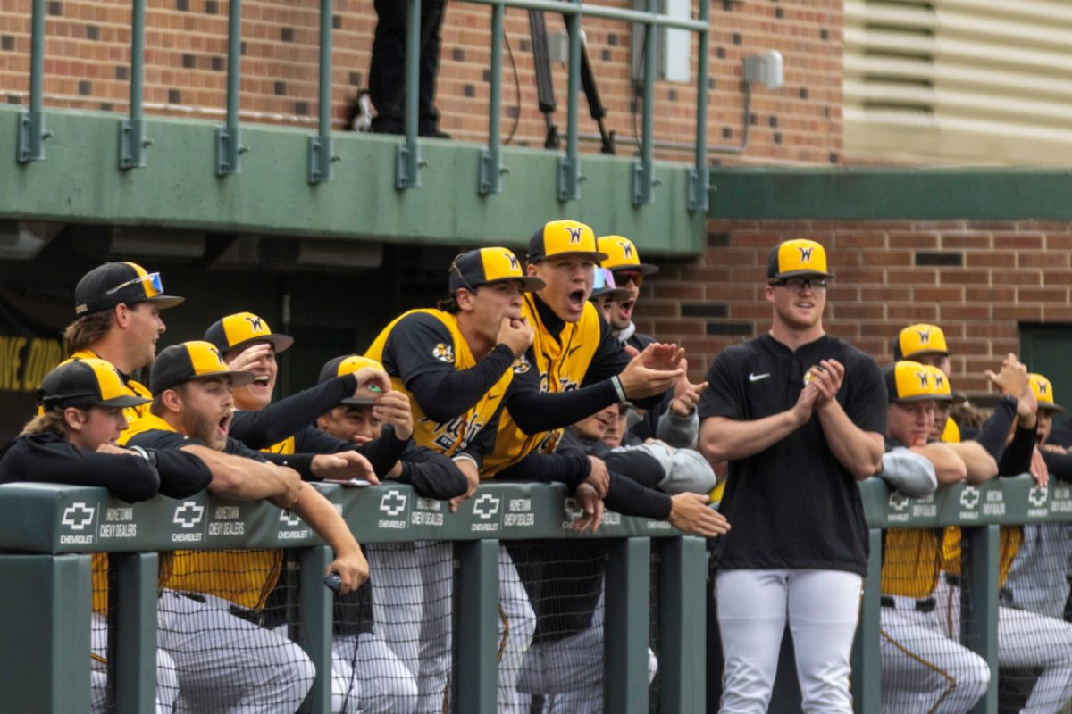 Wichita State's baseball team cheers from the dugout against No. 11 Kansas on April 28 at Eck Stadium. The Shockers lost, 14-1.