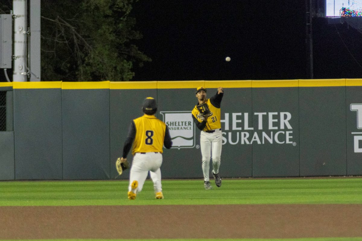 Wichita State baseball senior outfielder Jaden Gustafson (8) throws the ball to graduate infielder Alex Ulloa (8) during a game against No. 11 Kansas on April 28 at Eck Stadium. The Jayhawks collected five extra-base hits against the Shockers.
