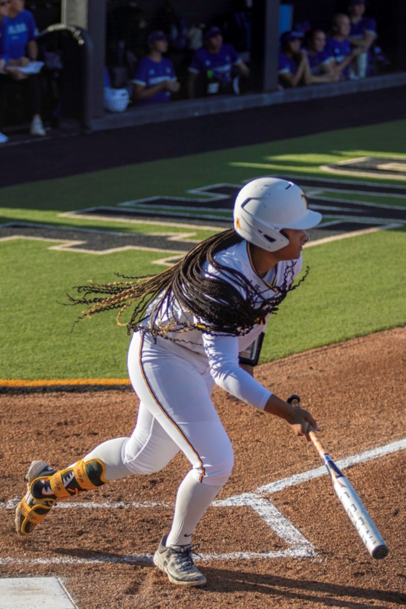 Wichita State softball sophomore Ausha Moore (81) sprints to first base after making contact against Tulsa on April 2 at Wilkins Stadium. Moore hit 0-for-4 during the game.