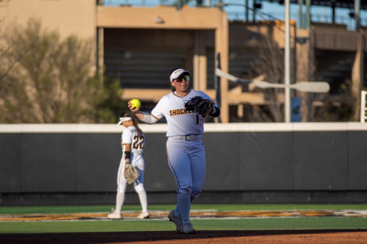 Wichita State softball senior Chloe Rhine (1) tosses the ball back to the pitcher during a game against Tulsa on April 2 at Wilkins Stadium. The Shockers lost, 11-10.