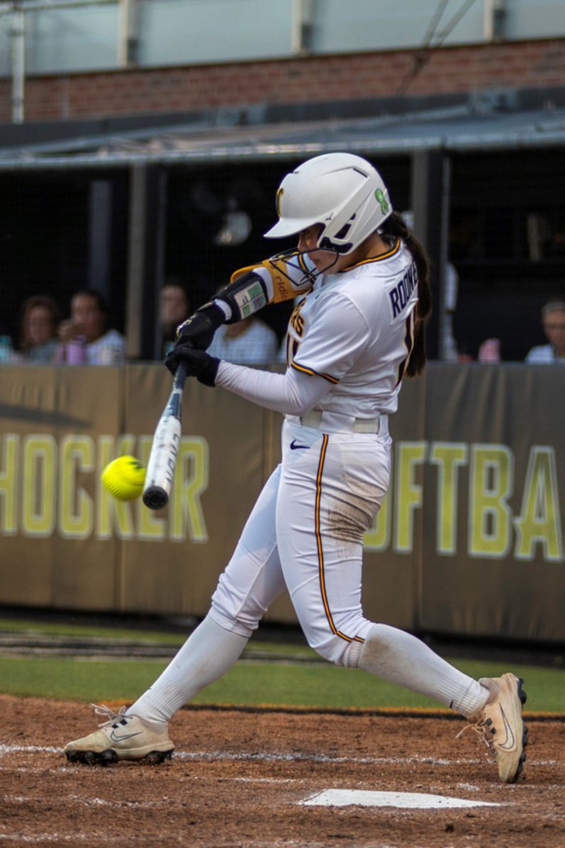 Wichita State softball freshman Mackenzie Rooney (11) makes contact against Tulsa on April 2 at Wilkins Stadium. Rooney hit 1-for-4 with two runs in the Shockers' 11-10 loss.
