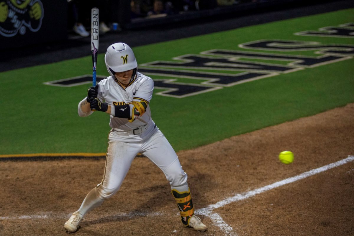 Wichita State softball senior Chloe Rhine (1) watches a ball come into the zone against Tulsa on April 2 at Wilkins Stadium. Rhine hit 1-for-1 and coerced two walks.