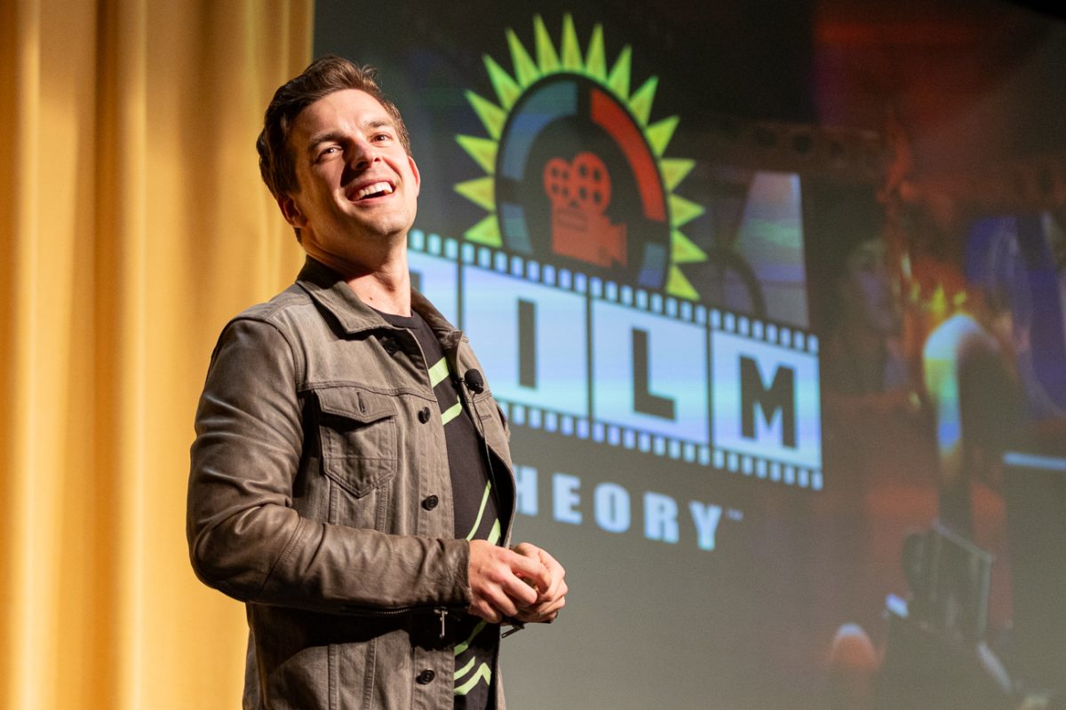Content Creator Matthew "MatPat" Patrick smiles as the crowd applauds his description of his second channel "Film Theory." Patrick originally started on YouTube with his channel, "Game Theory."