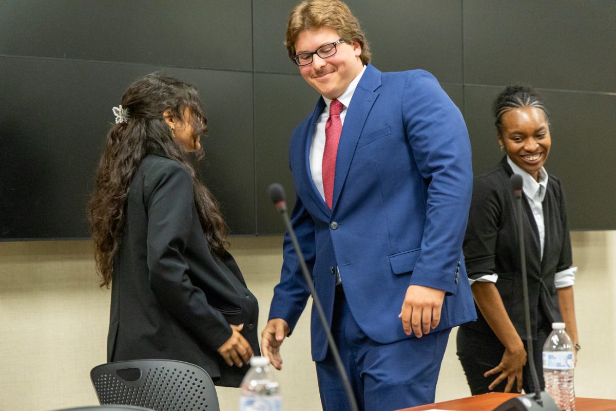 Presidential candidate Mason Fouquet and vice presidential candidate Anoushka Raju go in for a handshake at the end of the second presidential debate.