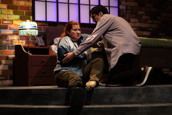 Colton Farmer, playing James, helps pick up Mia Dennett, playing Sarah, after her character fell on stage. The play was performed in two acts, with an intermission.