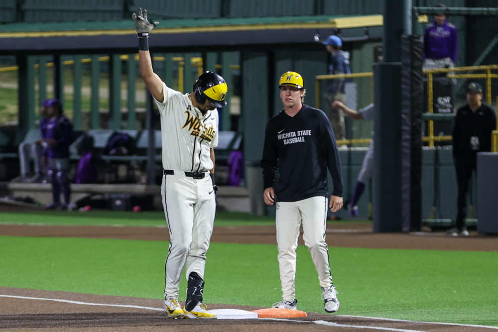 Wichita State baseball senior Jayson Jones (23) throws up the Wu Shock sign after a hit against Kansas State on April 7 at Eck Stadium. Jones extended hit hitting streak to 25 games.
