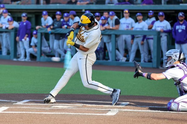Wichita State baseball senior Jaden Gustafson (21) makes contact with against Kansas State on April 7 at Eck Stadium. Gustafson hit 2-for-5 in the Shockers' 10-6 loss. (File photo)