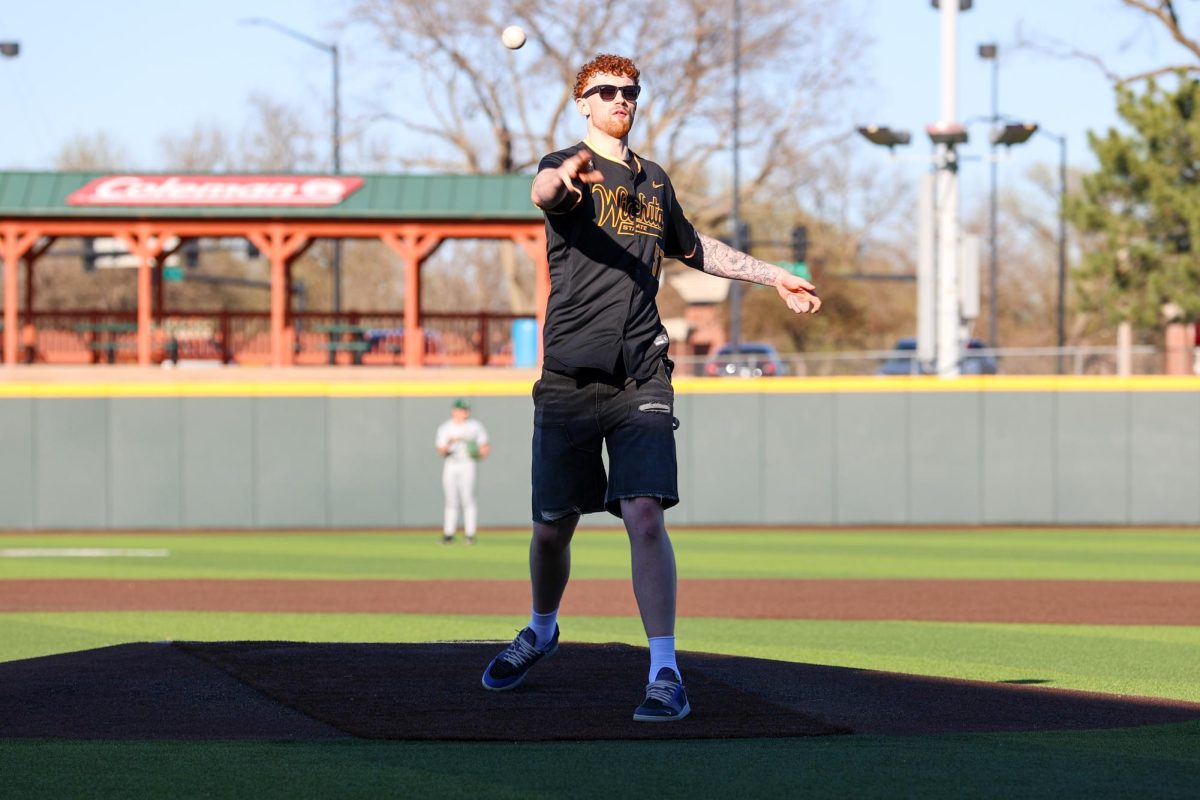 Wichita State men's basketball center Will Berg throws the game's ceremonial first pitch before the baseball team played Tulane on April 2 at Eck Stadium. Berg was joined by other teammates before the game.